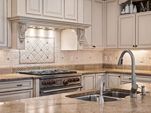 1200 Shipman Blvd, Birmingham, MI 48009 - kitchen with high end stainless steel range oven, decorative backsplash, and light stone counters