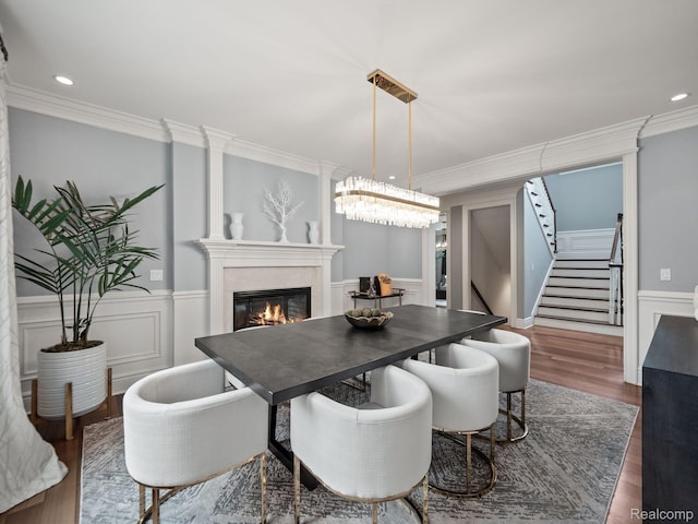 1200 Shipman Blvd, Birmingham, MI 48009 - dining room featuring stairway, dark wood-style floors, a glass covered fireplace, crown molding, and wainscoting