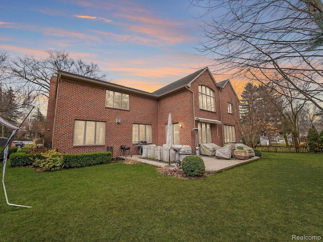 1200 Shipman Blvd, Birmingham, MI 48009 - back of property at dusk with a patio area and brick siding