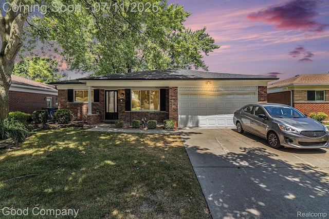3847 Dwight Dr, Warren, MI 48092 - view of front of home featuring an attached garage, driveway, brick siding, and a lawn