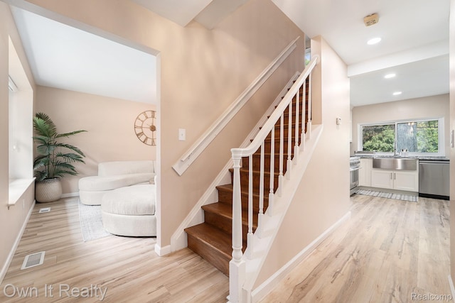 14128 Ellen Dr, Dearborn Heights, MI 48154 - stairs featuring wood finished floors and recessed lighting