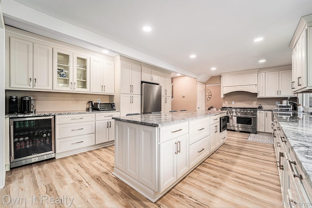 14128 Ellen Dr, Dearborn Heights, MI 48154 - kitchen with stainless steel appliances, wine cooler, a kitchen island, recessed lighting, and light wood finished floors