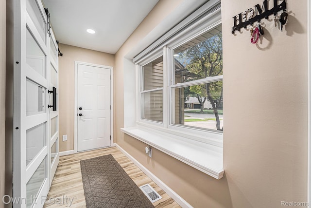 14128 Ellen Dr, Dearborn Heights, MI 48154 - mudroom featuring light wood finished floors, a barn door, and recessed lighting