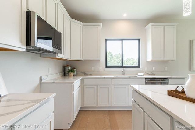3184 Roma Ct, Wixom, MI 48393 - kitchen with appliances with stainless steel finishes, light stone countertops, white cabinetry, and recessed lighting