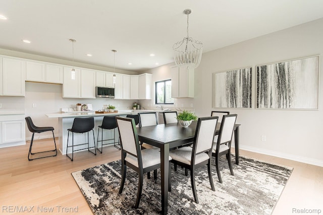 3184 Roma Ct, Wixom, MI 48393 - dining room featuring a chandelier, light wood-style floors, and recessed lighting