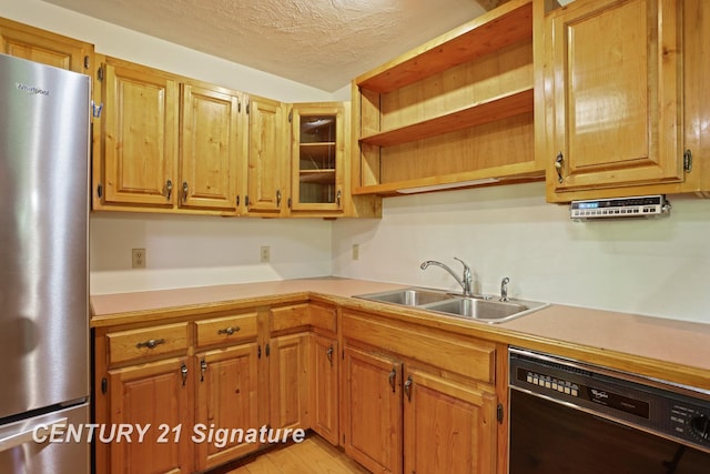 13715 Baldwin Rd, Saginaw, MI 48616 - kitchen featuring freestanding refrigerator, dishwasher, light countertops, a textured ceiling, and light wood finished floors