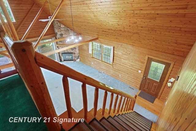 13715 Baldwin Rd, Saginaw, MI 48616 - stairs featuring wooden walls, wood ceiling, carpet flooring, and high vaulted ceiling