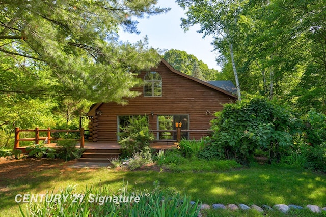 13715 Baldwin Rd, Saginaw, MI 48616 - rear view of house featuring a wooden deck, log siding, and a lawn
