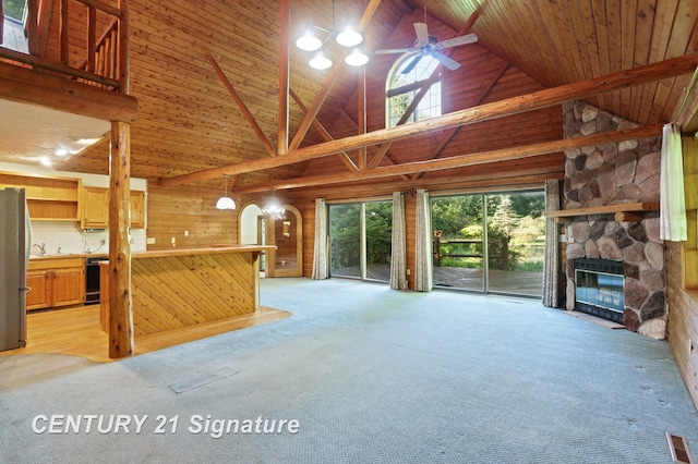 13715 Baldwin Rd, Saginaw, MI 48616 - unfurnished living room with high vaulted ceiling, light carpet, a fireplace, and ceiling fan
