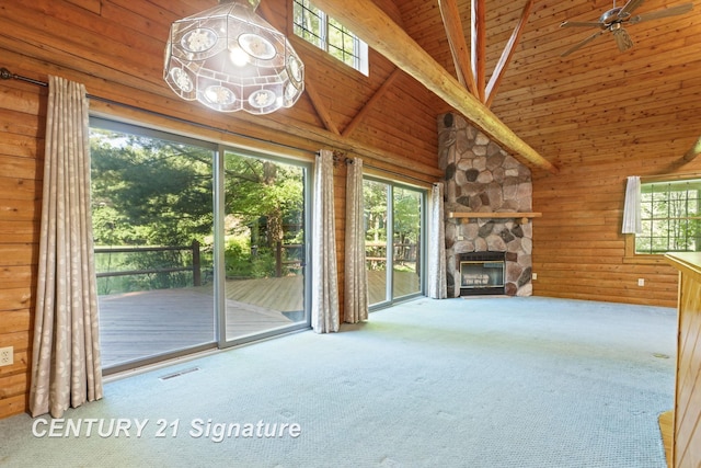 13715 Baldwin Rd, Saginaw, MI 48616 - unfurnished living room with carpet floors, high vaulted ceiling, a stone fireplace, wood ceiling, and wood walls