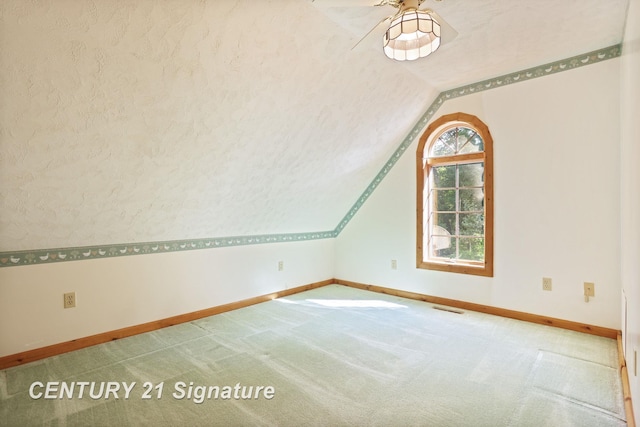 13715 Baldwin Rd, Saginaw, MI 48616 - additional living space with vaulted ceiling, a ceiling fan, and carpet flooring