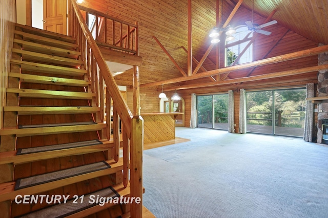 13715 Baldwin Rd, Saginaw, MI 48616 - unfurnished living room featuring high vaulted ceiling, carpet floors, stairway, wooden walls, and wood ceiling