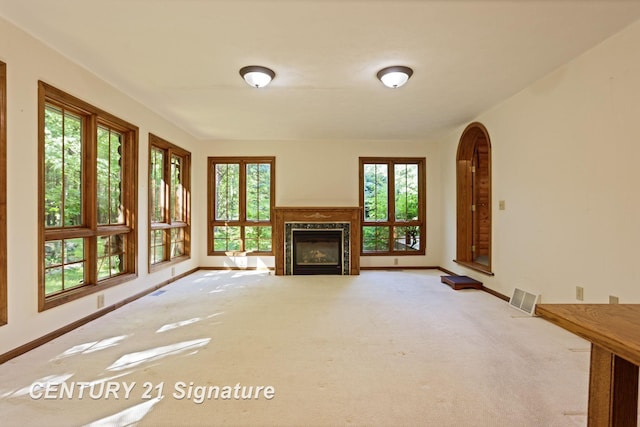13715 Baldwin Rd, Saginaw, MI 48616 - unfurnished living room with carpet, healthy amount of natural light, and a glass covered fireplace