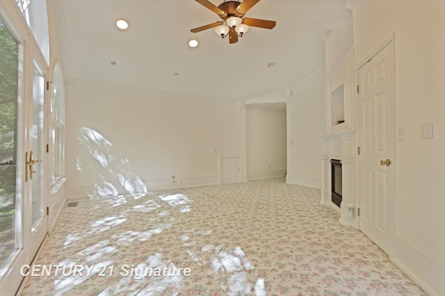 13715 Baldwin Rd, Saginaw, MI 48616 - spare room featuring ornamental molding, ceiling fan, carpet floors, a glass covered fireplace, and lofted ceiling