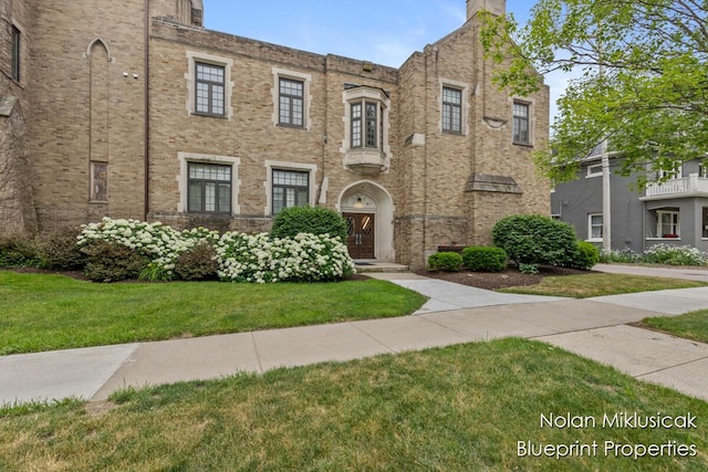 253 Prospect Ave NE Unit 309, Grand Rapids, MI 49503 - view of front of home with a front yard and brick siding