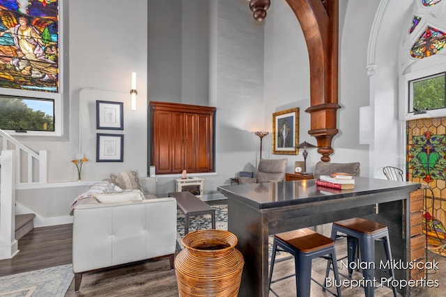 253 Prospect Ave NE Unit 309, Grand Rapids, MI 49503 - living room with stairs, a high ceiling, and wood finished floors