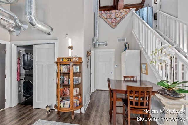 253 Prospect Ave NE Unit 309, Grand Rapids, MI 49503 - dining area with stacked washing machine and dryer, dark wood-style flooring, and stairs
