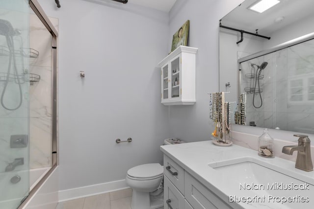 253 Prospect Ave NE Unit 309, Grand Rapids, MI 49503 - bathroom with vanity, tile patterned flooring, and combined bath / shower with glass door