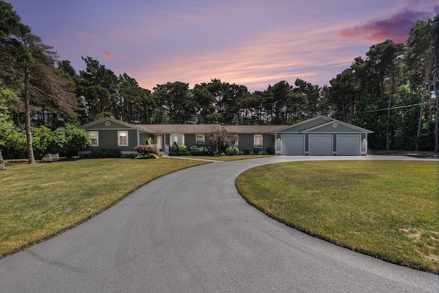 5920 Iris Rd, Ludington, MI 49431 - single story home featuring driveway, a front yard, and view of scattered trees