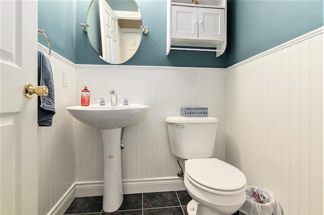 5920 Iris Rd, Ludington, MI 49431 - bathroom featuring tile patterned flooring and a wainscoted wall