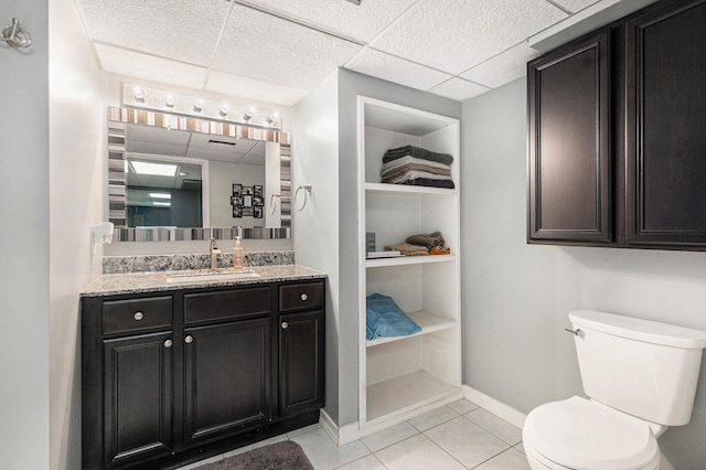 5920 Iris Rd, Ludington, MI 49431 - bathroom with vanity, tile patterned flooring, and a paneled ceiling