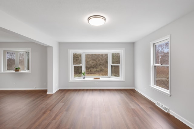 10833 W O Ave, Michigan, MI 49071 - unfurnished living room with healthy amount of natural light and dark wood-style flooring