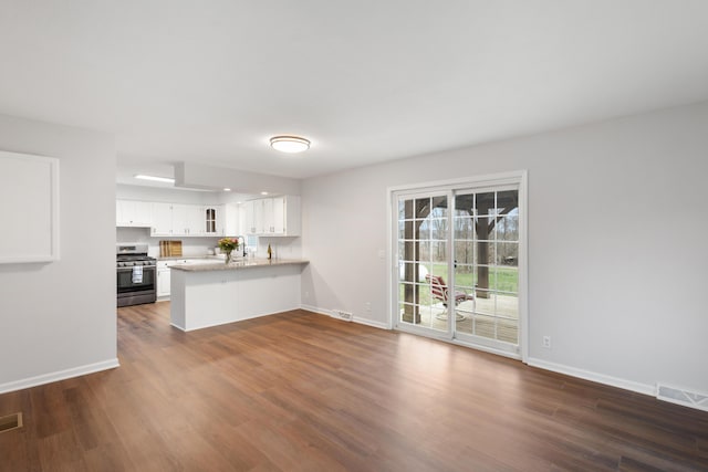 10833 W O Ave, Michigan, MI 49071 - unfurnished living room featuring baseboards and dark wood-style floors