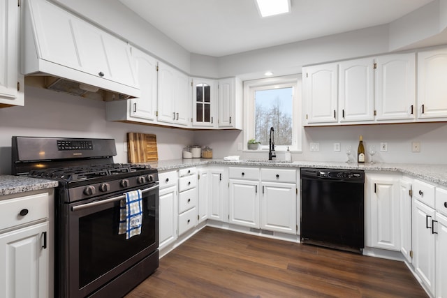 10833 W O Ave, Michigan, MI 49071 - kitchen with stainless steel gas stove, black dishwasher, white cabinets, light stone counters, and dark wood finished floors