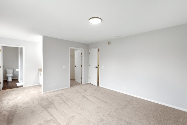 10833 W O Ave, Michigan, MI 49071 - unfurnished bedroom with carpet flooring, a spacious closet, connected bathroom, and a closet