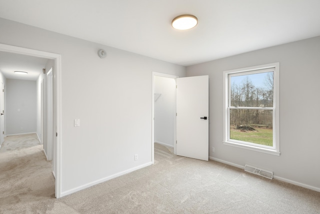 10833 W O Ave, Michigan, MI 49071 - unfurnished bedroom featuring light colored carpet, multiple windows, and a spacious closet