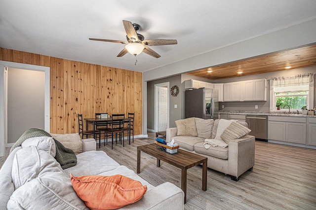 24984 Marcellus Hwy, Dowagiac, MI 49047 - living room with ceiling fan, wood walls, and light wood-style flooring