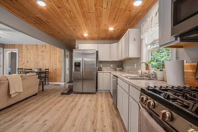 24984 Marcellus Hwy, Dowagiac, MI 49047 - kitchen with stainless steel appliances, wood ceiling, light wood finished floors, white cabinetry, and wooden walls