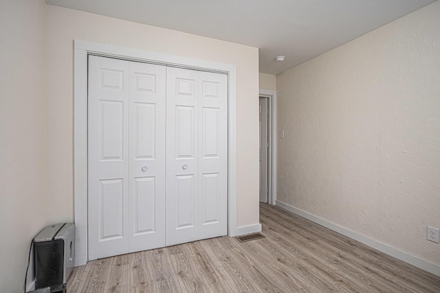 24984 Marcellus Hwy, Dowagiac, MI 49047 - unfurnished bedroom featuring light wood-style floors and a closet