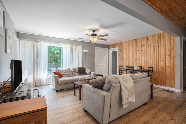 24984 Marcellus Hwy, Dowagiac, MI 49047 - living room with ceiling fan, wooden walls, and light wood-style flooring