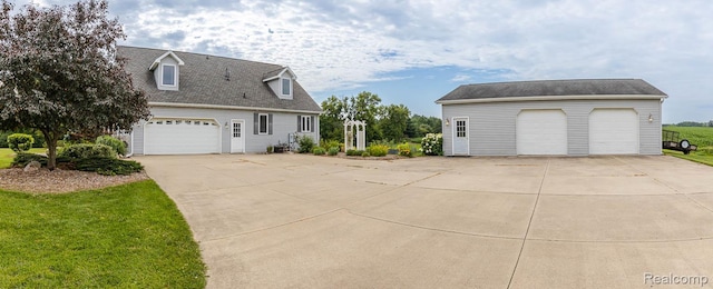 2086 Haines Rd, Lapeer, MI 48446 - view of side of property with a detached garage and an outdoor structure