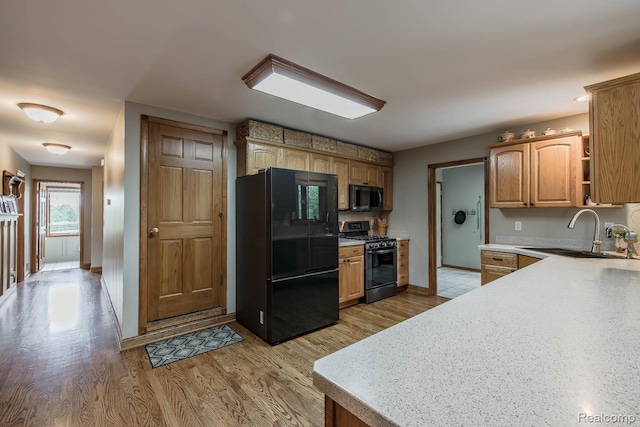 2086 Haines Rd, Lapeer, MI 48446 - kitchen with freestanding refrigerator, gas stove, stainless steel microwave, light wood-style floors, and open shelves