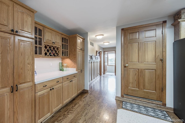 2086 Haines Rd, Lapeer, MI 48446 - kitchen featuring glass insert cabinets, light countertops, and wood finished floors