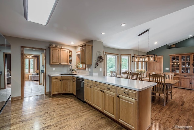2086 Haines Rd, Lapeer, MI 48446 - kitchen featuring dishwasher, light countertops, light wood-type flooring, a peninsula, and vaulted ceiling