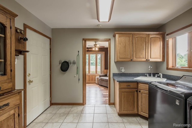 2086 Haines Rd, Lapeer, MI 48446 - kitchen featuring dark countertops, a ceiling fan, and washing machine and dryer