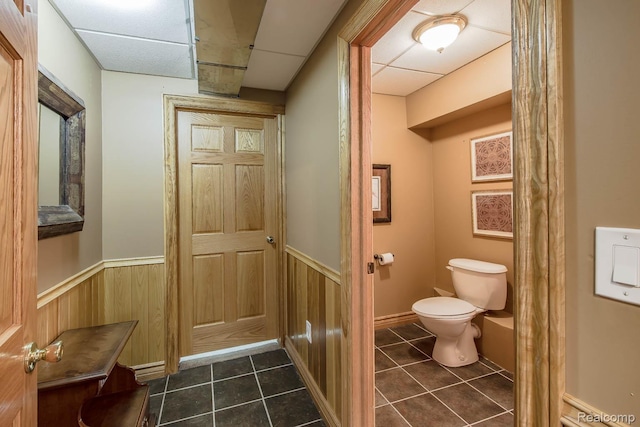 2086 Haines Rd, Lapeer, MI 48446 - bathroom featuring wainscoting, tile patterned flooring, a drop ceiling, and wood walls