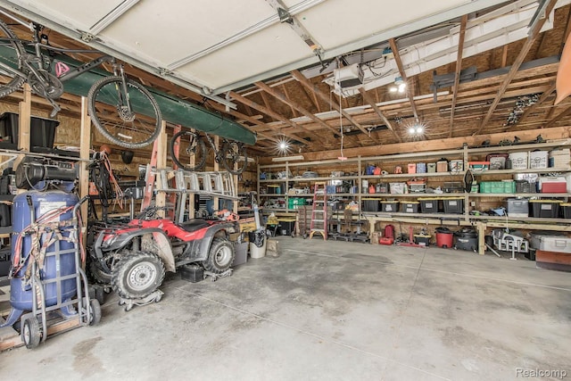 2086 Haines Rd, Lapeer, MI 48446 - garage with a garage door opener and a workshop area