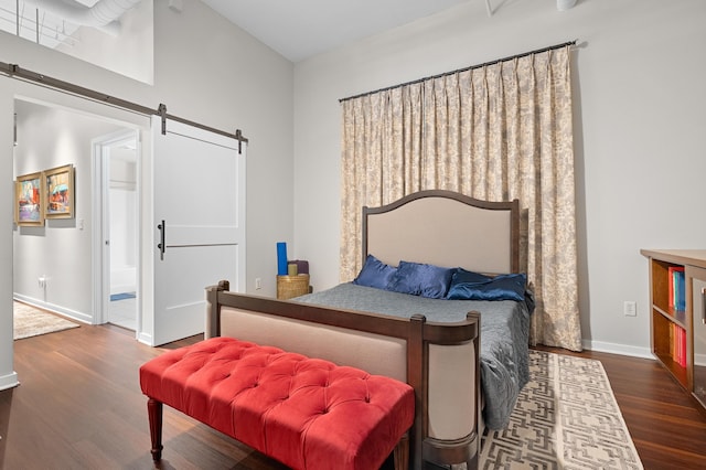 125 S Kalamazoo Mall Unit 603, Kalamazoo, MI 49007 - bedroom with a barn door, wood finished floors, and ensuite bath