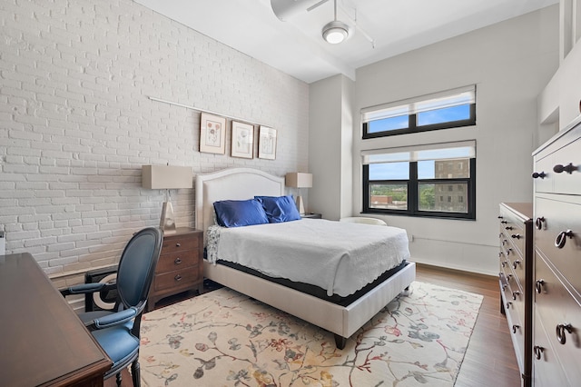 125 S Kalamazoo Mall Unit 603, Kalamazoo, MI 49007 - bedroom with wood finished floors and brick wall