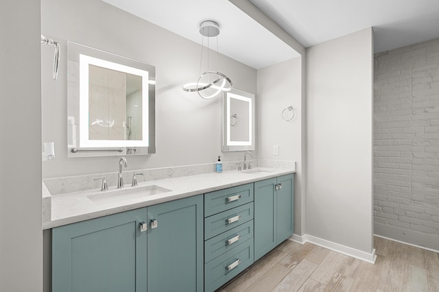 125 S Kalamazoo Mall Unit 603, Kalamazoo, MI 49007 - full bathroom with double vanity, wood finished floors, and brick wall