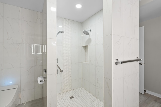 125 S Kalamazoo Mall Unit 603, Kalamazoo, MI 49007 - bathroom featuring a tile shower, tile walls, recessed lighting, and wood finished floors