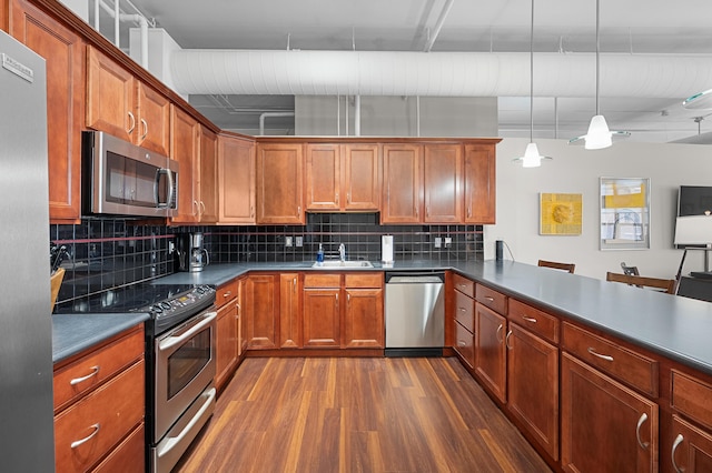 125 S Kalamazoo Mall Unit 603, Kalamazoo, MI 49007 - kitchen with stainless steel appliances, dark wood-style flooring, decorative backsplash, and dark countertops