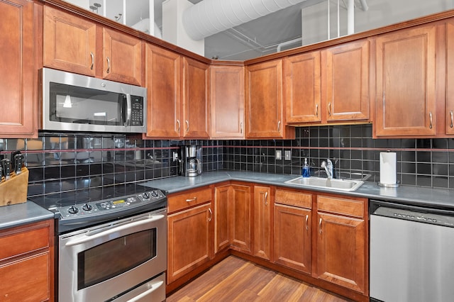 125 S Kalamazoo Mall Unit 603, Kalamazoo, MI 49007 - kitchen featuring appliances with stainless steel finishes, brown cabinets, and light wood-style flooring