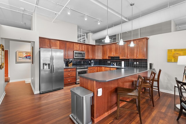 125 S Kalamazoo Mall Unit 603, Kalamazoo, MI 49007 - kitchen with appliances with stainless steel finishes, a high ceiling, rail lighting, a peninsula, and decorative backsplash