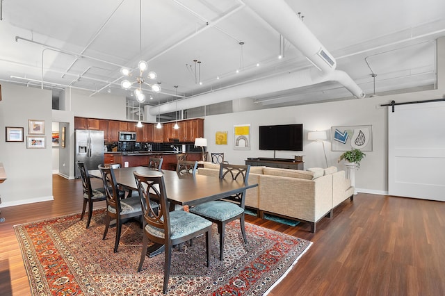 125 S Kalamazoo Mall Unit 603, Kalamazoo, MI 49007 - dining space featuring a barn door, dark wood finished floors, and a chandelier