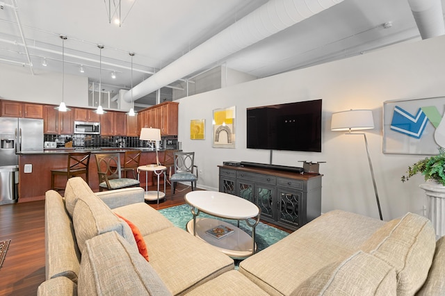 125 S Kalamazoo Mall Unit 603, Kalamazoo, MI 49007 - living area with dark wood-type flooring, a high ceiling, and rail lighting